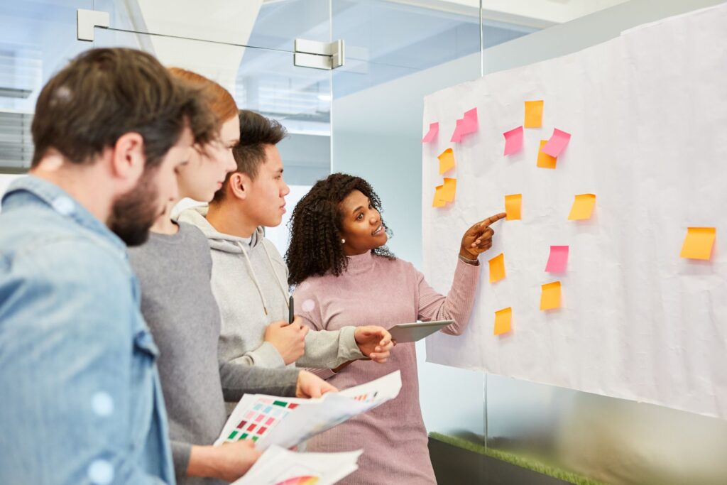 A startup team is brainstorming together to tackle common digital marketing mistakes and come up with smart solutions.