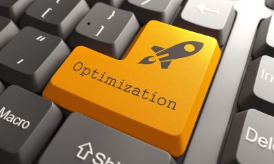 Close-up of a computer keyboard with a bright orange key labeled 'Optimization' and a rocket icon, symbolizing website optimization for speed and efficiency.