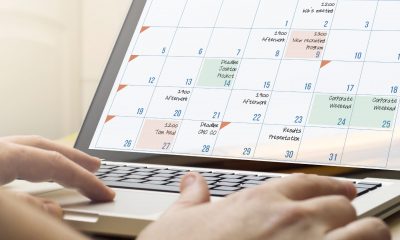 A laptop displaying a content calendar filled with deadlines, and marketing-related events.